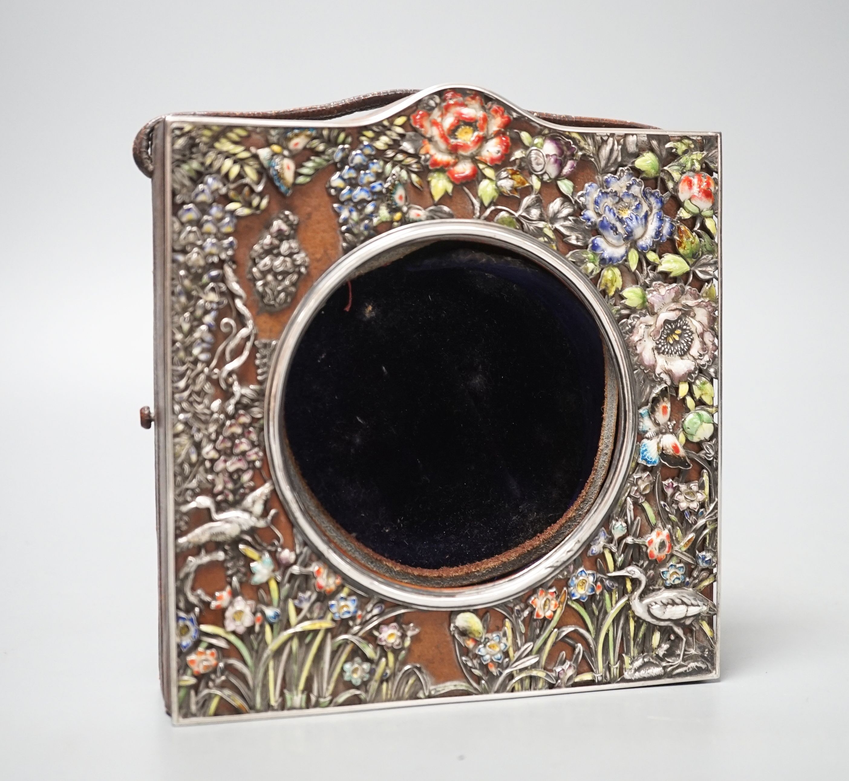 An early 20th century Japanese? white metal and polychrome enamel mounted leather travelling watch case, decorated with flowers and birds, 16.2cm.